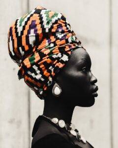 woman wearing orange, white, and black scarf