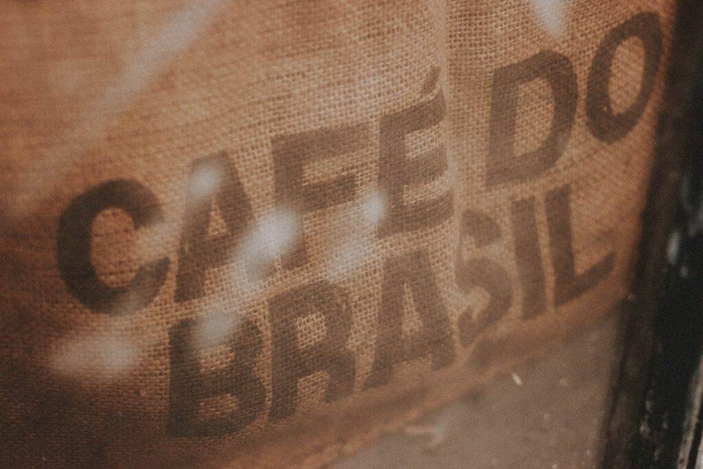 High angle closeup of burlap bag with coffee beans and inscription Cafe Do Brasil