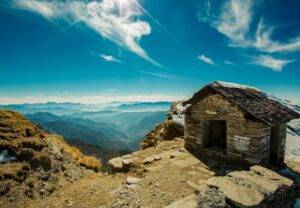 brown wooden house on mountain cliff