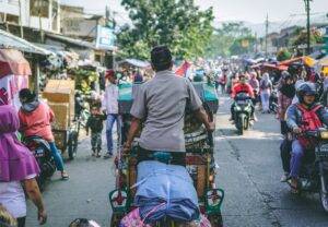 selective photography of man pedaling wagon