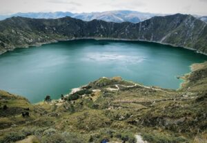 Breathtaking aerial view of Quilotoa crater lake surrounded by the majestic Andes mountains in Ecuador.